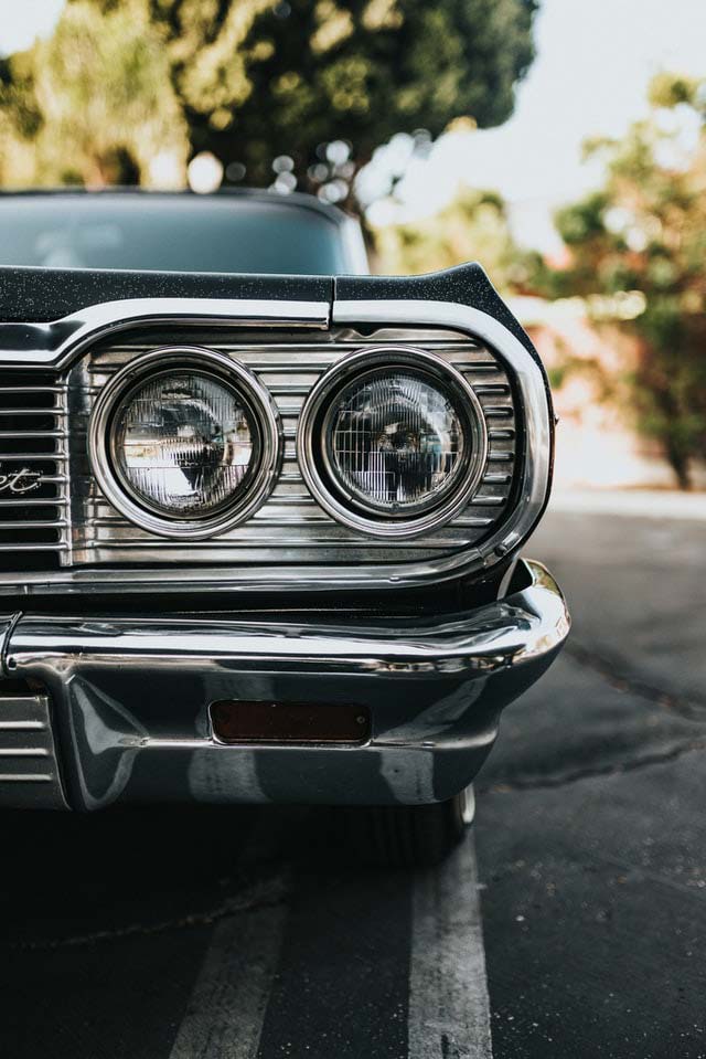 close up of front headlight of 1960s chevy impala